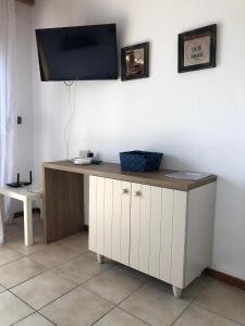 a desk with a television on top of a wall at Seafront Family Apartment Ellie in Skala Fourkas