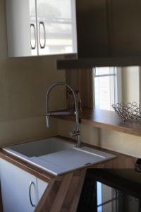 a kitchen counter with a sink in a kitchen at La parenthèse in Dijon