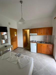 a kitchen with brown cabinets and a white stove at NAKOU FREIDERIKI ANTHOUSA PARGAs in Parga