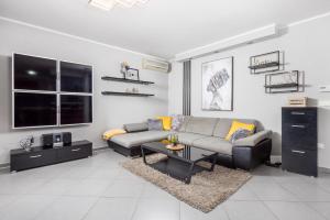 a living room with a couch and a table at SkyRiver in Rijeka
