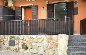 a house with a fence and a stone wall at Vulcano in Pozzallo