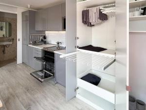 a kitchen with white cabinets and a sink at El ático de Madrid, vistas a la ciudad in Madrid