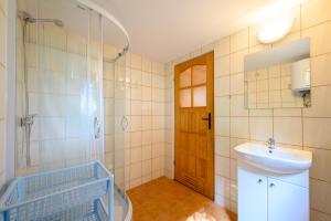 a bathroom with a sink and a toilet and a mirror at Domki nad morzem - Nevada in Darlowko +20 photos
