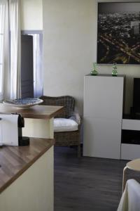 a kitchen with a table and a couch and a table at La parenthèse in Dijon