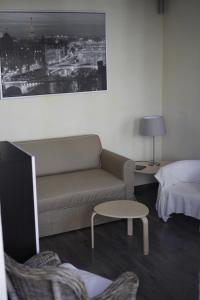 a living room with a couch and a bed at La parenthèse in Dijon