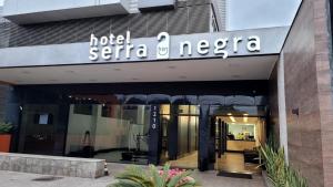 a building with a sign that reads not serta necca at Hotel Serra Negra in Betim