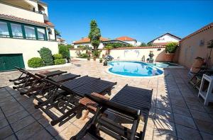 a group of chairs and a swimming pool at Villa David in Vodice