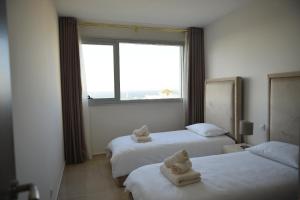 a hotel room with two beds with towels on them at Tanger City Center Residences Suites & sea view in Tangier