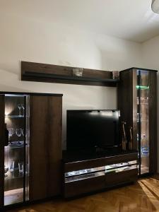 a entertainment center with a flat screen tv in a living room at Apartment in Shtip in Štip