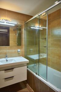 a bathroom with a glass shower and a sink at Tanger City Center Residences Suites & sea view in Tangier +26 photos