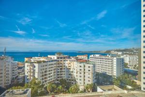 a view of a city with buildings and the ocean at Tanger City Center Residences Suites & sea view in Tangier