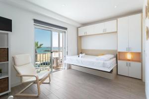 a bedroom with a bed and a balcony with the ocean at Stunning Studio with Beach Front- Astro Quarteira by Centralgarve in Quarteira