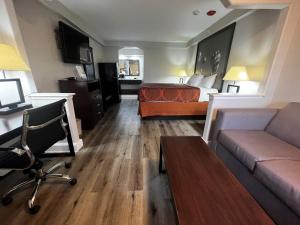 a hotel room with a bed and a couch at Super 8 by Wyndham Mont Belvieu - Baytown East in Eldon