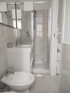 a bathroom with a toilet and a shower and a sink at Mare Luna Apartment in Bari