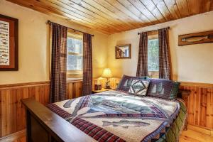 1 dormitorio con 1 cama en una cabaña de madera en Falls Brook Camp, en Stowe