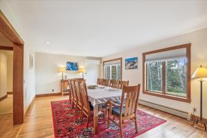 a dining room with a table and chairs at Mountain Falls in Stowe
