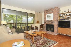 a living room with a fireplace and a television at Notchbrook 2AB in Stowe