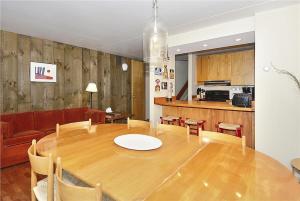 a dining room and kitchen with a wooden table at Notchbrook 2AB in Stowe