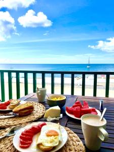 a table with breakfast food and a view of the beach at Villa Playa Honda in Playa Honda