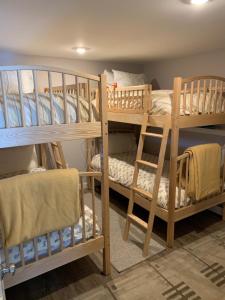 a room with two bunk beds and a chair at Owls' Nest in Stowe