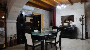 a dining room with a black table and chairs at Petrini Villa with swimming pool in Kapparianá