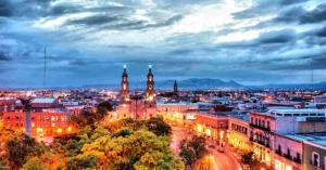 a city skyline at night with a clock tower at En el Centro 3 Hermoso Loft Familiar AC WiFi 300 mbps in Aguascalientes