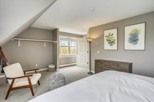 ein Schlafzimmer mit einem weißen Bett und einem Stuhl in der Unterkunft Hollow House in Stowe