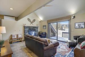 a living room with a couch and a fireplace at Stowe Base Camp 21 in Stowe