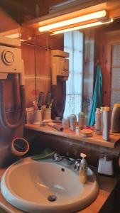 a bathroom with a sink and a large mirror at La Casetta in Codevilla - Roburent in Roa Marenca