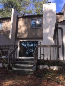 a home with stairs leading to the front door at Villa at Bethany West in Bethany Beach