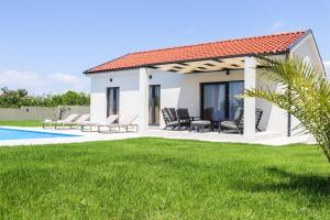 a villa with a swimming pool and a resort at Villa Gemini in Zadar