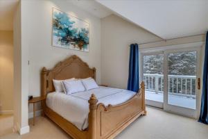 a bedroom with a bed and a large window at Edson Hill Estate in Stowe