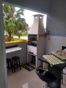 a kitchen with a counter and stools in a room at Apartamento Ubatuba in Ubatuba