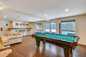 a living room with a pool table and a couch at Edson Hill Estate in Stowe