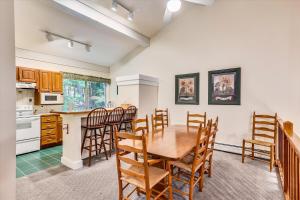 a kitchen and dining room with a table and chairs at Tollhouse 16A in Stowe