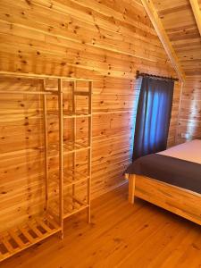 a log cabin bedroom with a bed and a window at lemon garden bungalow in Demre