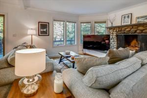 a living room with two couches and a fireplace at Topnotch Retreat in Stowe