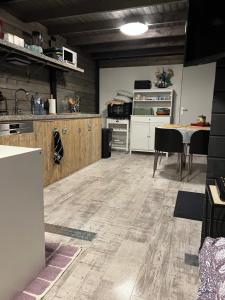 a large kitchen with a table and chairs and a counter at Vrijstaand Houten huis in het bos in Haaksbergen +16 photos