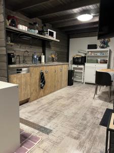 a kitchen with wooden cabinets and a counter top at Vrijstaand Houten huis in het bos in Haaksbergen