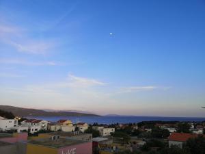 a view of a city with the ocean in the background at Apartman The View Krk in Krk