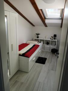 a small bedroom with a bed and a window at Apartman The View Krk in Krk
