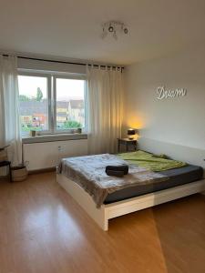 um quarto com uma cama grande e uma janela grande em Möblierte Wohnung in Duisburg em Duisburgo