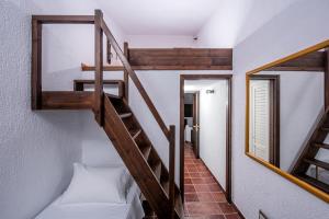een trap in een kamer met een bed en een spiegel bij Villa Sunrise Majestic Seaview with Private Pool in Chersonissos