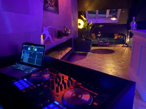 a recording room with a laptop on a mixing desk at LoCo Paradiso - Two kingsize beds, outdoor terrace, DJ booth, bar, cinema, bathtub, kitchen, airco in Antwerp