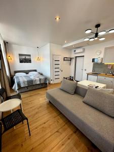 a living room with a couch and a bed at Arcadia apartment & sea terrace in Odesa