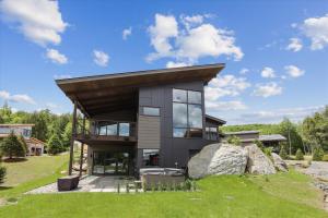 a modern house with a roof on a grass field at Natures Way in Stowe