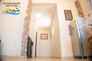 a hallway with a refrigerator in a house at Ranch Percebu Beach Studio 3 in Don Pancho