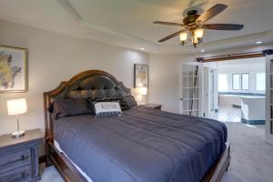 a bedroom with a large bed with a ceiling fan at Spacious Refuge with Private Pool and Outdoor Bar! in Amherst +37 photos