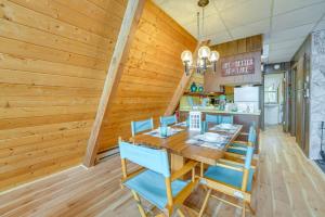 a dining room with a table and blue chairs at Long Lake Cabin Rental with Private Dock! in Fountain