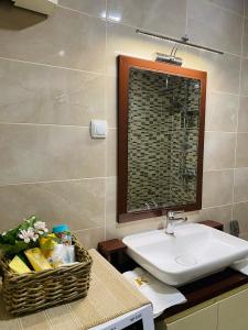 a bathroom with a sink and a basket on a counter at Apartment in Shtip in Štip